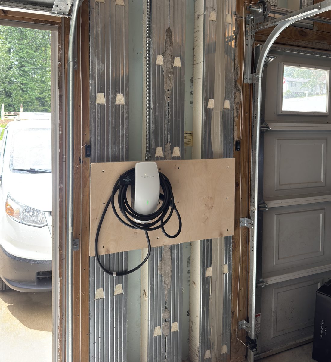 Tesla Wall Connector EV charger installed in a Winston-Salem garage by Amped Up Electrical Solutions