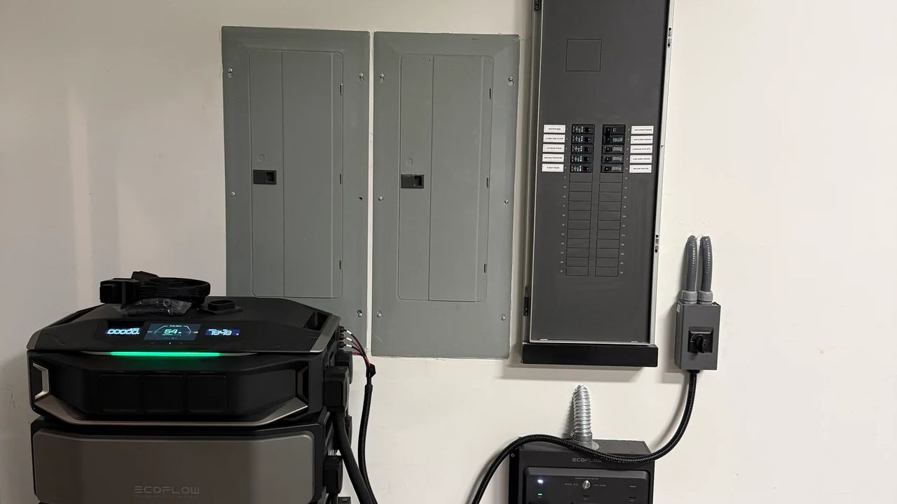 Home battery storage and electrical panels installed together in a garage