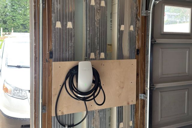 Hardwired Tesla Wall Connector fed by a dedicated circuit in armored cable, with no receptacle in the run