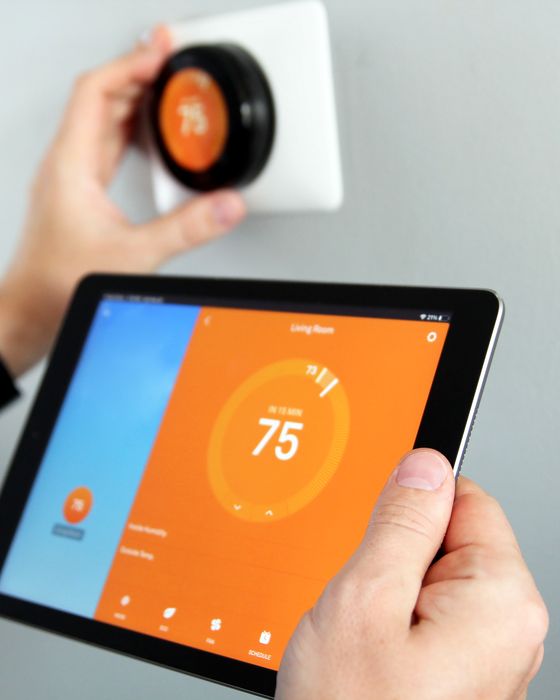 Wall-mounted smart home control panel showing a floor plan of the house