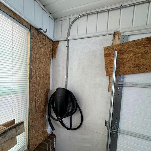 EV charger and coiled connector mounted inside a Lewisville, NC garage