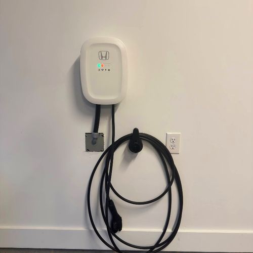 Wall-mounted Level 2 EV charger fed from a dedicated 240V outlet