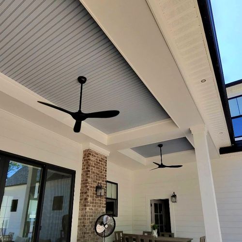 Ceiling fan installed on a vaulted shiplap ceiling in a living room