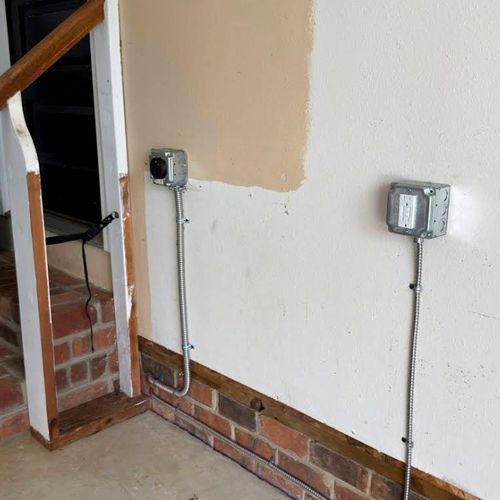 New outlets and conduit run on an interior wall during a Kernersville, NC rewire