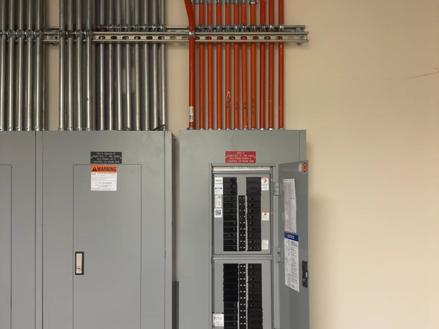 Main panel and subpanel with conduit and branch wiring run to them on a residential job