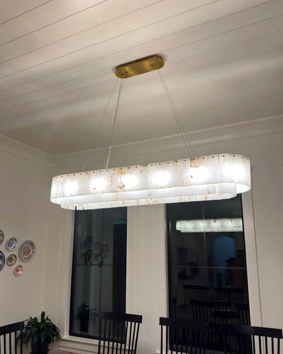Pendant lights hung in a run over a kitchen island