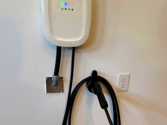 Level 2 EV charger installed on a garage wall